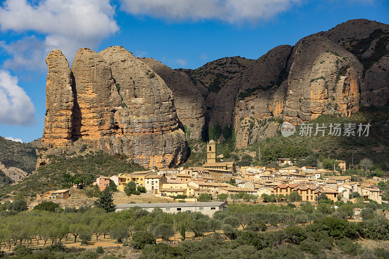 Famous climb walls mountains of Mallos de Agüero (Aguero cliffs) in Huesca and the Agüero village in the foreground.